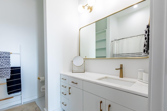 1900 12th Ave S Unit 502, Nashville, TN 37203 - bathroom with toilet, vanity, and baseboards