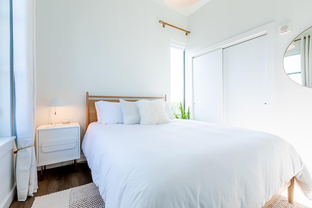 1900 12th Ave S Unit 502, Nashville, TN 37203 - bedroom with dark wood-style floors, a closet, and multiple windows