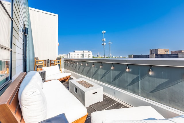 1900 12th Ave S Unit 502, Nashville, TN 37203 - balcony featuring an outdoor living space with a fire pit and a view of city