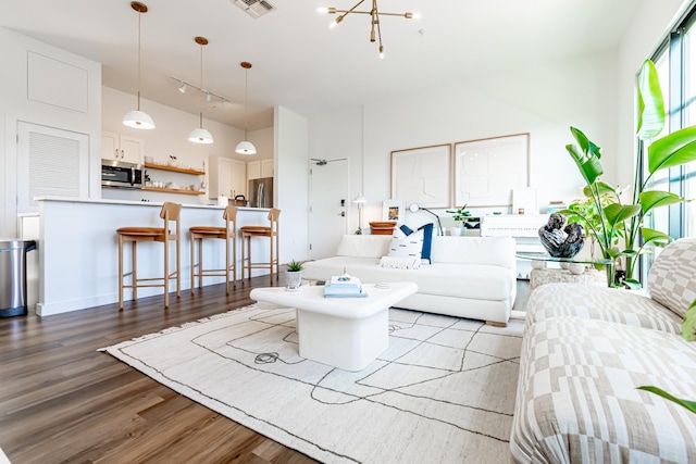 1900 12th Ave S Unit 502, Nashville, TN 37203 - living room with rail lighting, light wood-type flooring, and a chandelier