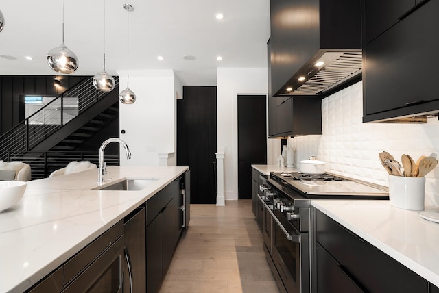 112 47th Ave N, Nashville, TN 37209 - kitchen with a sink, double oven range, wall chimney exhaust hood, light wood-style floors, and dark cabinetry