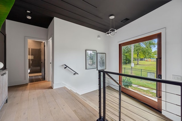 112 47th Ave N, Nashville, TN 37209 - hall with an upstairs landing, light wood-style flooring, a chandelier, and baseboards