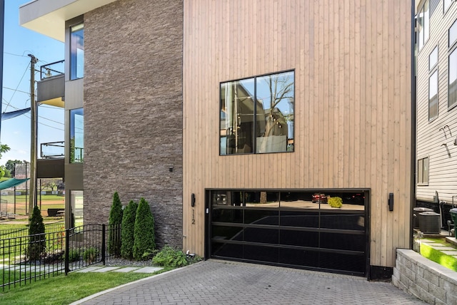 112 47th Ave N, Nashville, TN 37209 - view of home's exterior with an attached garage, decorative driveway, and central AC unit