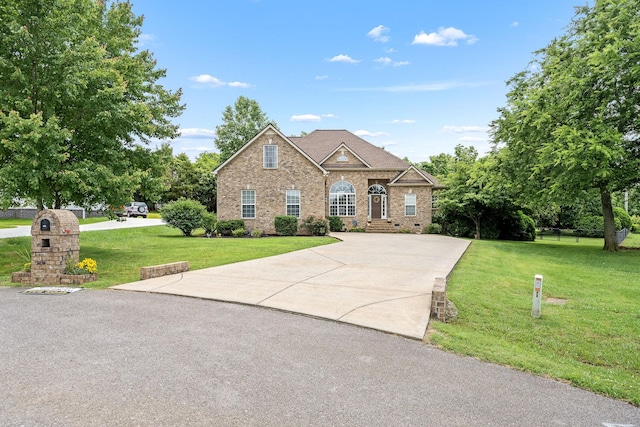 116 Macy Ct, Christiana, TN 37037 - view of front of house featuring driveway, a front yard, and brick siding