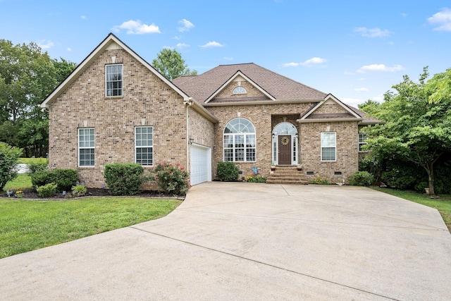 116 Macy Ct, Christiana, TN 37037 - view of front of house featuring concrete driveway, brick siding, a front lawn, and an attached garage