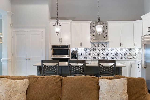 140 Split Rail Ln, Spring Hill, TN 37174 - kitchen featuring stainless steel appliances, open floor plan, white cabinetry, and backsplash