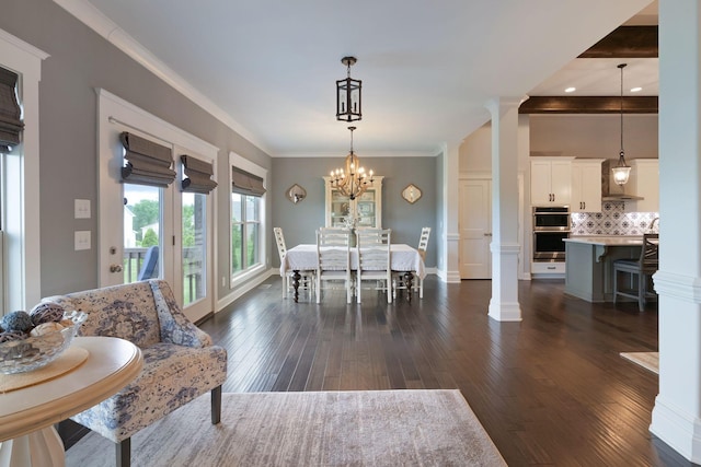 140 Split Rail Ln, Spring Hill, TN 37174 - dining room with dark wood finished floors, ornate columns, crown molding, a chandelier, and baseboards