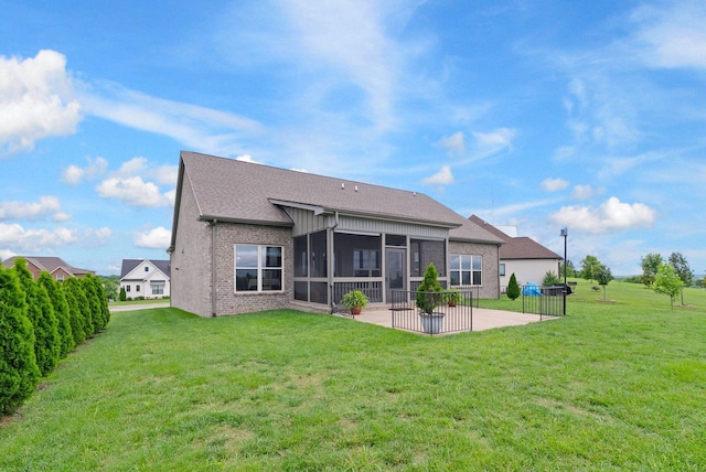140 Split Rail Ln, Spring Hill, TN 37174 - back of property featuring a patio, a sunroom, a lawn, brick siding, and roof with shingles