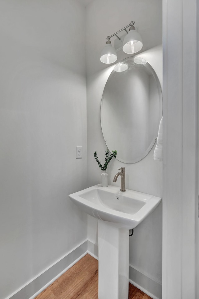 603 51st Ave, Nashville, TN 37209 - bathroom featuring baseboards, wood finished floors, and a sink