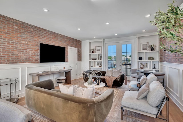 603 51st Ave, Nashville, TN 37209 - living room featuring a decorative wall, a wainscoted wall, recessed lighting, light wood finished floors, and brick wall
