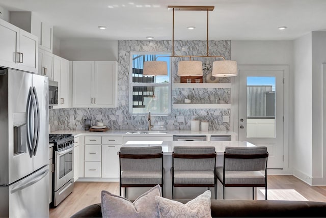 603 51st Ave, Nashville, TN 37209 - kitchen featuring appliances with stainless steel finishes, a sink, light countertops, backsplash, and recessed lighting