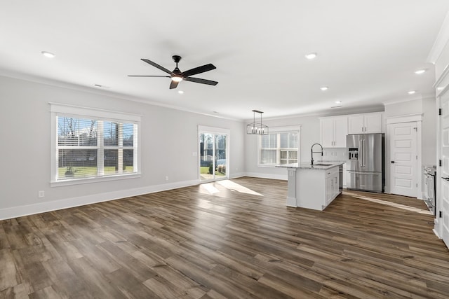 544 Kingwood Ln, White House, TN 37188 - unfurnished living room with a sink, ornamental molding, healthy amount of natural light, ceiling fan, and dark wood finished floors