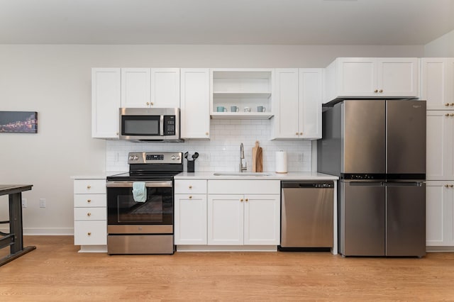 600 E Trinity Ln Unit 20, Nashville, TN 37207 - kitchen featuring stainless steel appliances, a sink, light countertops, and white cabinetry