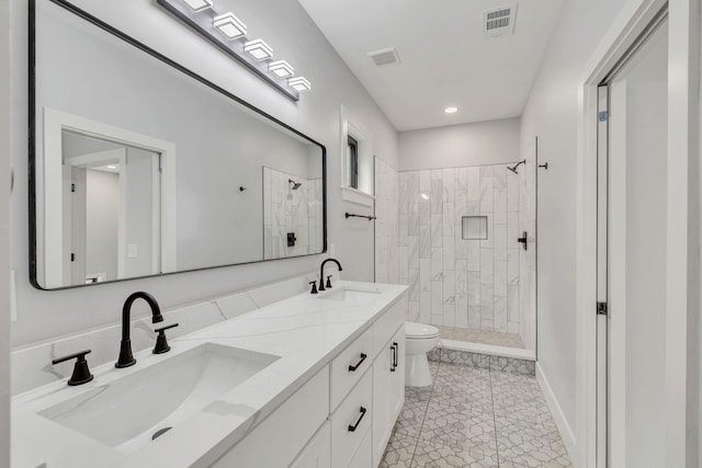 415 S University St, Murfreesboro, TN 37130 - bathroom featuring toilet, a tile shower, double vanity, tile patterned flooring, and recessed lighting