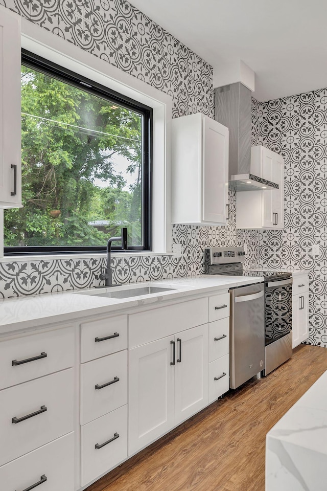 415 S University St, Murfreesboro, TN 37130 - kitchen featuring a sink, stove, white cabinets, and light wood-style floors