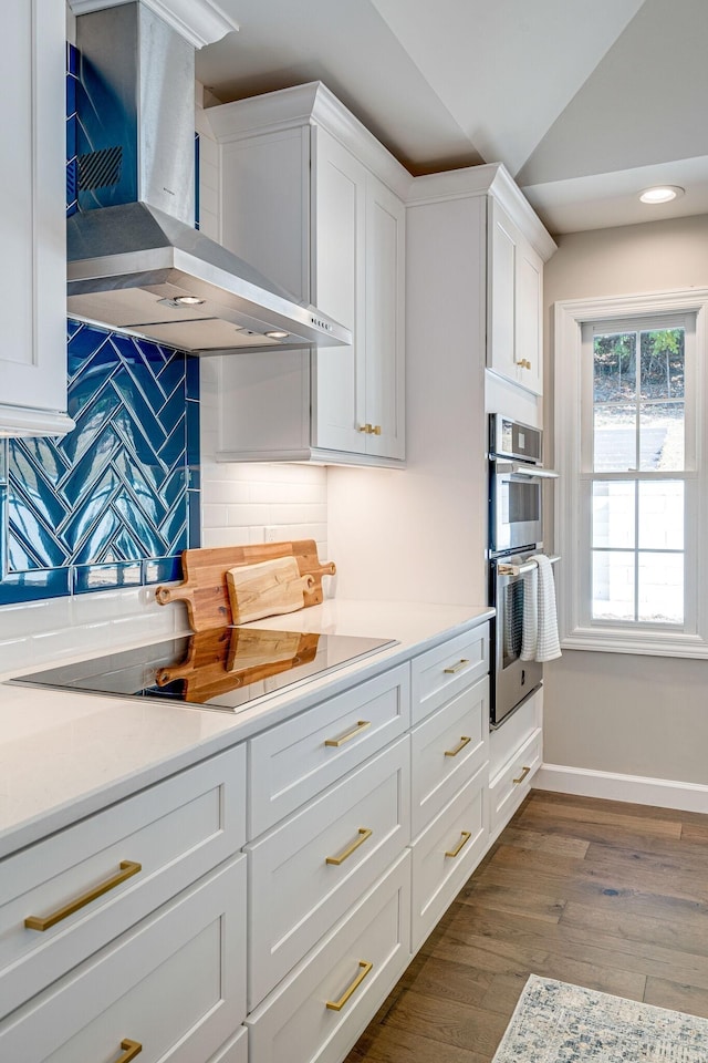 4626 Cato Rd, Nashville, TN 37218 - kitchen with wall chimney exhaust hood, tasteful backsplash, white cabinets, dark wood-type flooring, and light countertops
