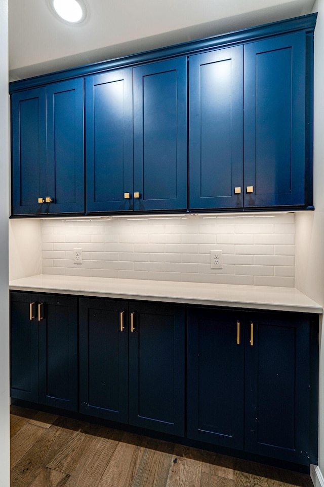 4626 Cato Rd, Nashville, TN 37218 - kitchen featuring blue cabinetry, dark wood-style flooring, light countertops, and backsplash