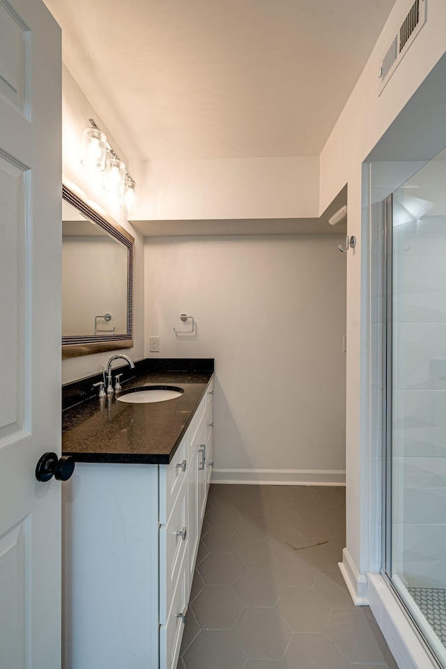 4626 Cato Rd, Nashville, TN 37218 - full bathroom featuring vanity, tile patterned floors, a stall shower, and baseboards