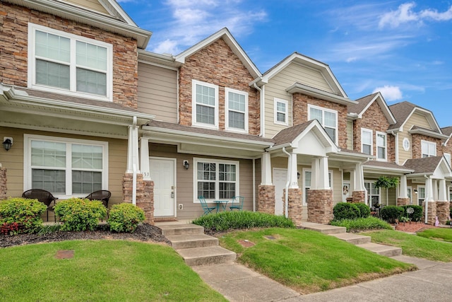 133 Cobblestone Place Dr, Goodlettsville, TN 37072 - view of property with stone siding, a front yard, and a porch