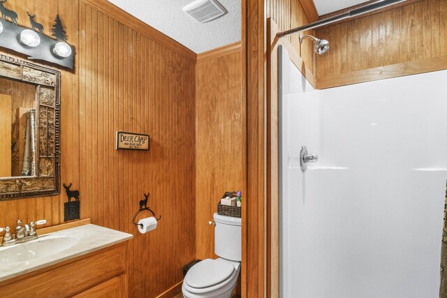 29 Roger Monk Rd, Petersburg, TN 37144 - bathroom with a shower stall, vanity, toilet, wooden walls, and a textured ceiling