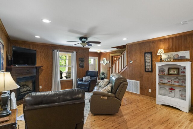 29 Roger Monk Rd, Petersburg, TN 37144 - living area featuring wooden walls, ceiling fan, stairs, light wood-style flooring, and a fireplace