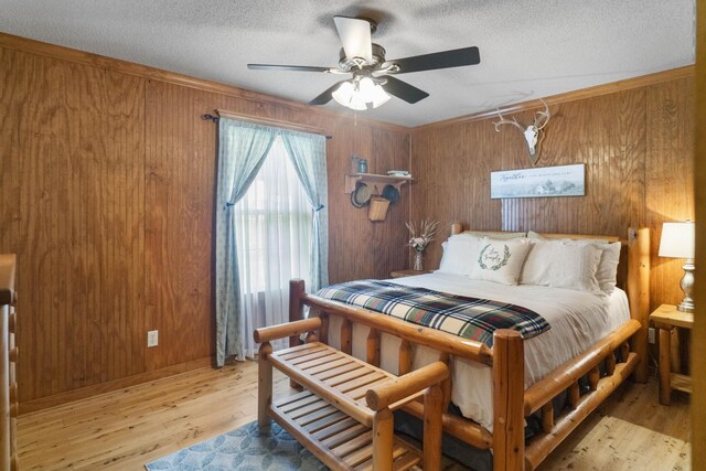 29 Roger Monk Rd, Petersburg, TN 37144 - bedroom featuring wooden walls, light wood-type flooring, a textured ceiling, and ceiling fan
