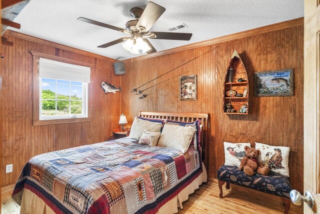 29 Roger Monk Rd, Petersburg, TN 37144 - bedroom with wood walls, wood finished floors, a textured ceiling, crown molding, and a ceiling fan