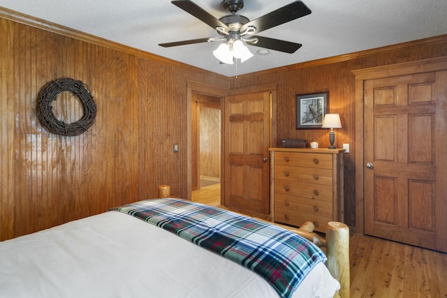 29 Roger Monk Rd, Petersburg, TN 37144 - bedroom with crown molding, wooden walls, light wood-type flooring, and ceiling fan