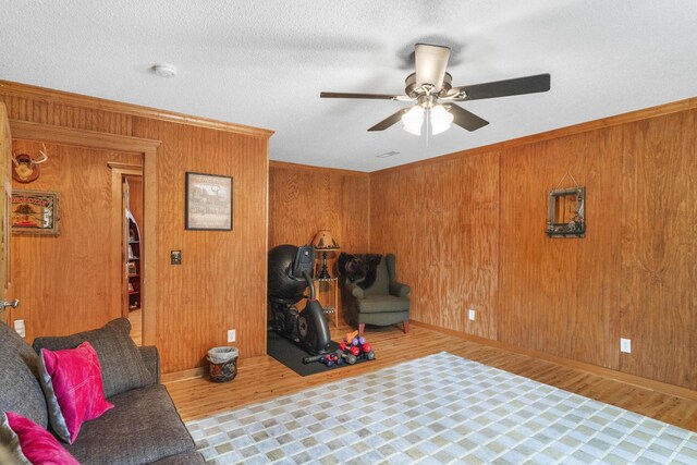 29 Roger Monk Rd, Petersburg, TN 37144 - living area with a ceiling fan, wood finished floors, wood walls, ornamental molding, and baseboards