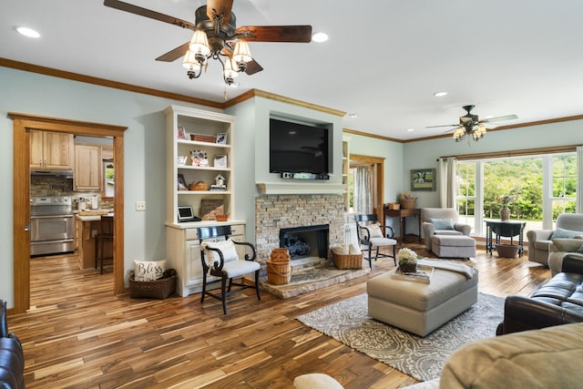 29 Roger Monk Rd, Petersburg, TN 37144 - living room featuring a ceiling fan, wood finished floors, crown molding, recessed lighting, and a fireplace