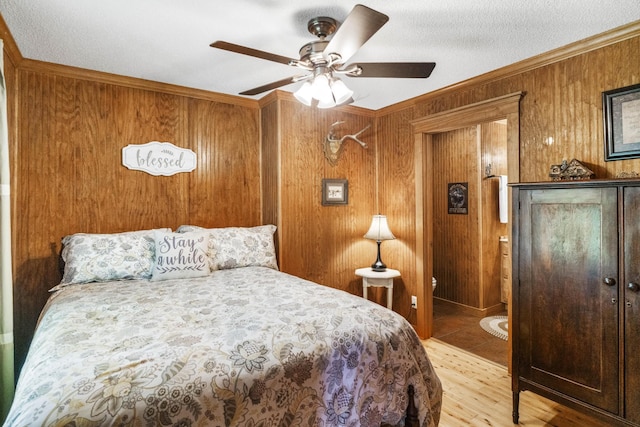 29 Roger Monk Rd, Petersburg, TN 37144 - bedroom featuring wooden walls, ornamental molding, light wood finished floors, ceiling fan, and a textured ceiling