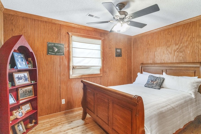 29 Roger Monk Rd, Petersburg, TN 37144 - bedroom featuring light wood-style floors, wooden walls, a textured ceiling, a ceiling fan, and ornamental molding