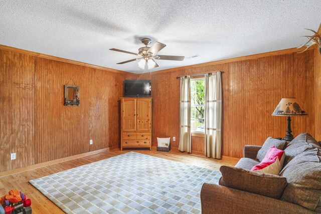 29 Roger Monk Rd, Petersburg, TN 37144 - sitting room featuring wood finished floors, a ceiling fan, wood walls, ornamental molding, and baseboards