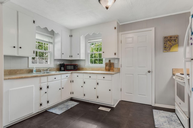 1818 Morningside Ave, Columbia, TN 38401 - kitchen featuring electric range, healthy amount of natural light, a sink, white cabinetry, and a textured ceiling