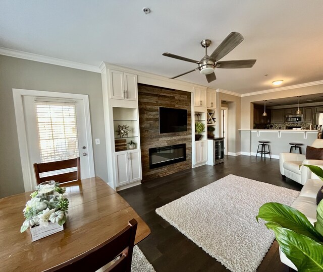 3201 Aspen Grove Dr Unit M4, Franklin, TN 37067 - living area featuring crown molding, a large fireplace, ceiling fan, dark wood-style flooring, and baseboards