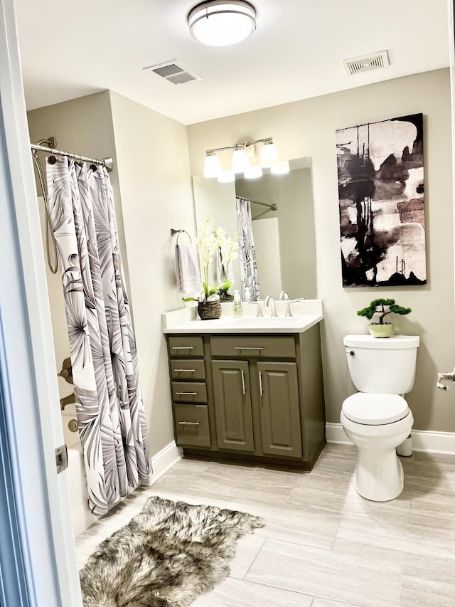 3201 Aspen Grove Dr Unit M4, Franklin, TN 37067 - bathroom with toilet, vanity, shower / bath combination with curtain, and baseboards