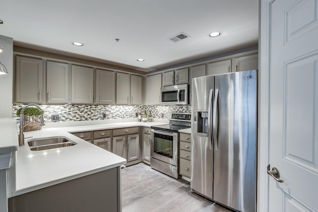 3201 Aspen Grove Dr Unit M4, Franklin, TN 37067 - kitchen with appliances with stainless steel finishes, gray cabinetry, a sink, light wood-type flooring, and recessed lighting