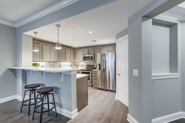 3201 Aspen Grove Dr Unit M4, Franklin, TN 37067 - kitchen featuring appliances with stainless steel finishes, a kitchen breakfast bar, a peninsula, gray cabinets, and ornamental molding