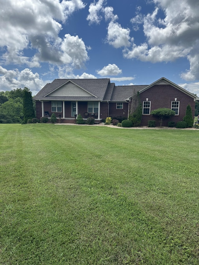 234 Glenn Springs Rd, Lawrenceburg, TN 38464 - ranch-style house featuring a front yard, covered porch, and brick siding