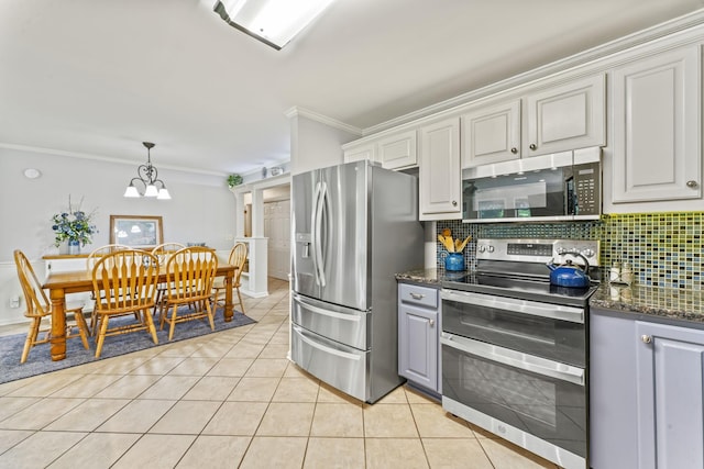 4312 Seminary Rd, Smyrna, TN 37167 - kitchen with appliances with stainless steel finishes, ornamental molding, tasteful backsplash, light tile patterned flooring, and a chandelier