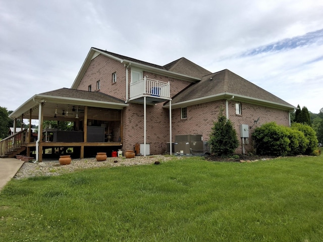 900 Sorghum Hollow Rd, Pulaski, TN 38478 - rear view of house with brick siding, a yard, a balcony, central AC, and a shingled roof