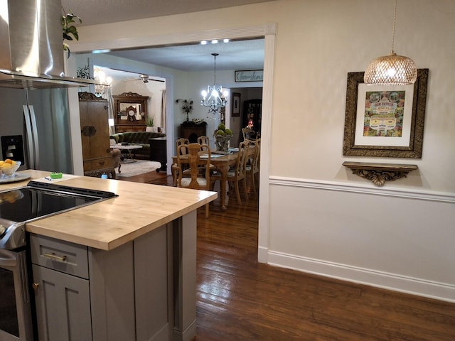 900 Sorghum Hollow Rd, Pulaski, TN 38478 - kitchen with stainless steel range with electric stovetop, butcher block countertops, dark wood finished floors, a chandelier, and hanging light fixtures