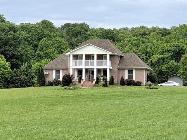 900 Sorghum Hollow Rd, Pulaski, TN 38478 - greek revival inspired property featuring covered porch, a balcony, a front yard, and a wooded view