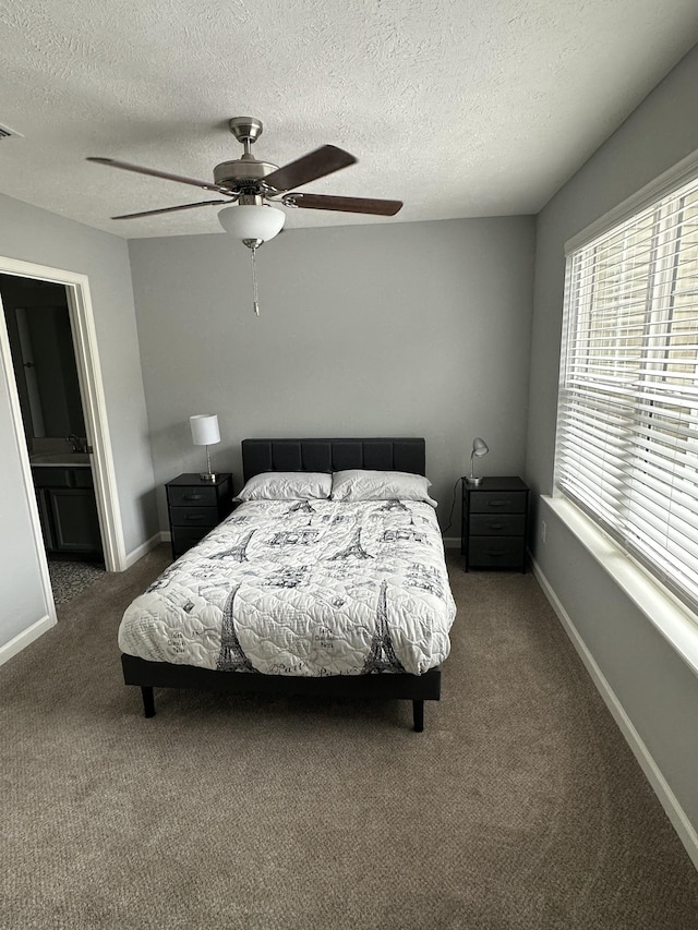 1158 Tradition Trl, Murfreesboro, TN 37130 - bedroom featuring carpet flooring, a textured ceiling, baseboards, a ceiling fan, and connected bathroom