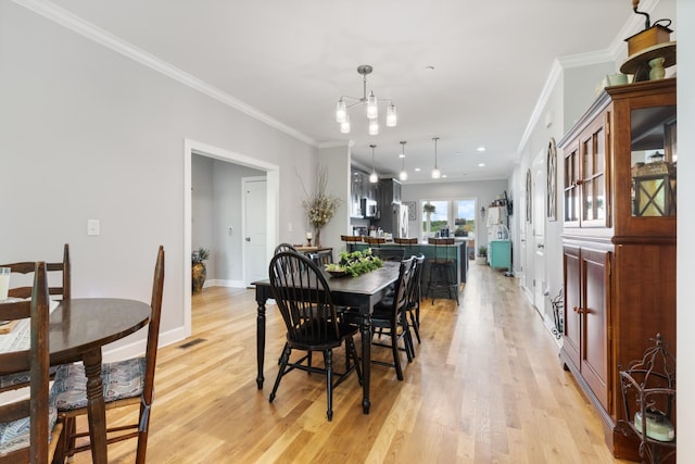 111 Madeleine Way, Kingston Springs, TN 37082 - dining space with light wood-style floors, crown molding, and baseboards