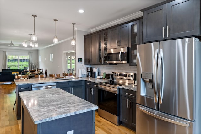 111 Madeleine Way, Kingston Springs, TN 37082 - kitchen featuring appliances with stainless steel finishes, crown molding, a peninsula, a sink, and glass insert cabinets