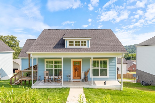 111 Madeleine Way, Kingston Springs, TN 37082 - view of front of house featuring a front yard, covered porch, roof with shingles, and central AC
