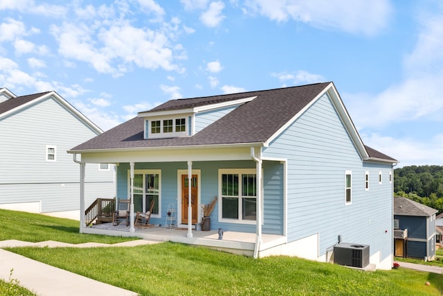 111 Madeleine Way, Kingston Springs, TN 37082 - view of front of house with central AC, a porch, a front yard, and roof with shingles