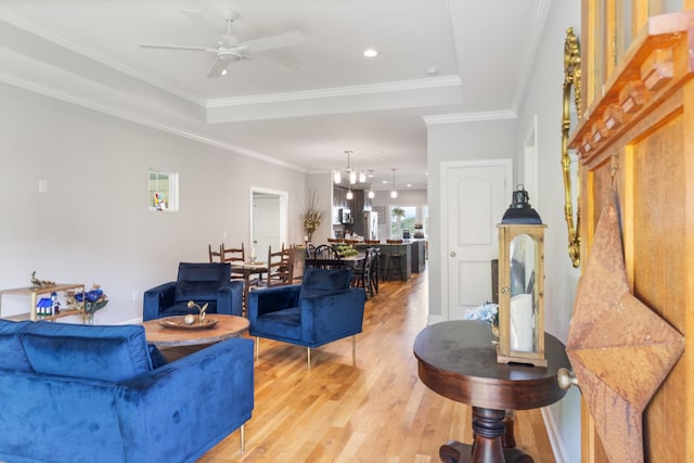111 Madeleine Way, Kingston Springs, TN 37082 - living room featuring light wood-type flooring, ceiling fan, a raised ceiling, ornamental molding, and a chandelier