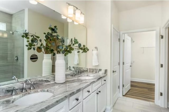 325 Sharp Way, Murfreesboro, TN 37128 - full bath with double vanity, tiled shower, a walk in closet, tile patterned floors, and baseboards